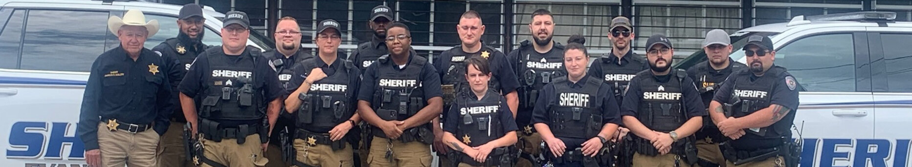 Evangeline Sheriff's Office Staff standing in front of sheriff vehicles